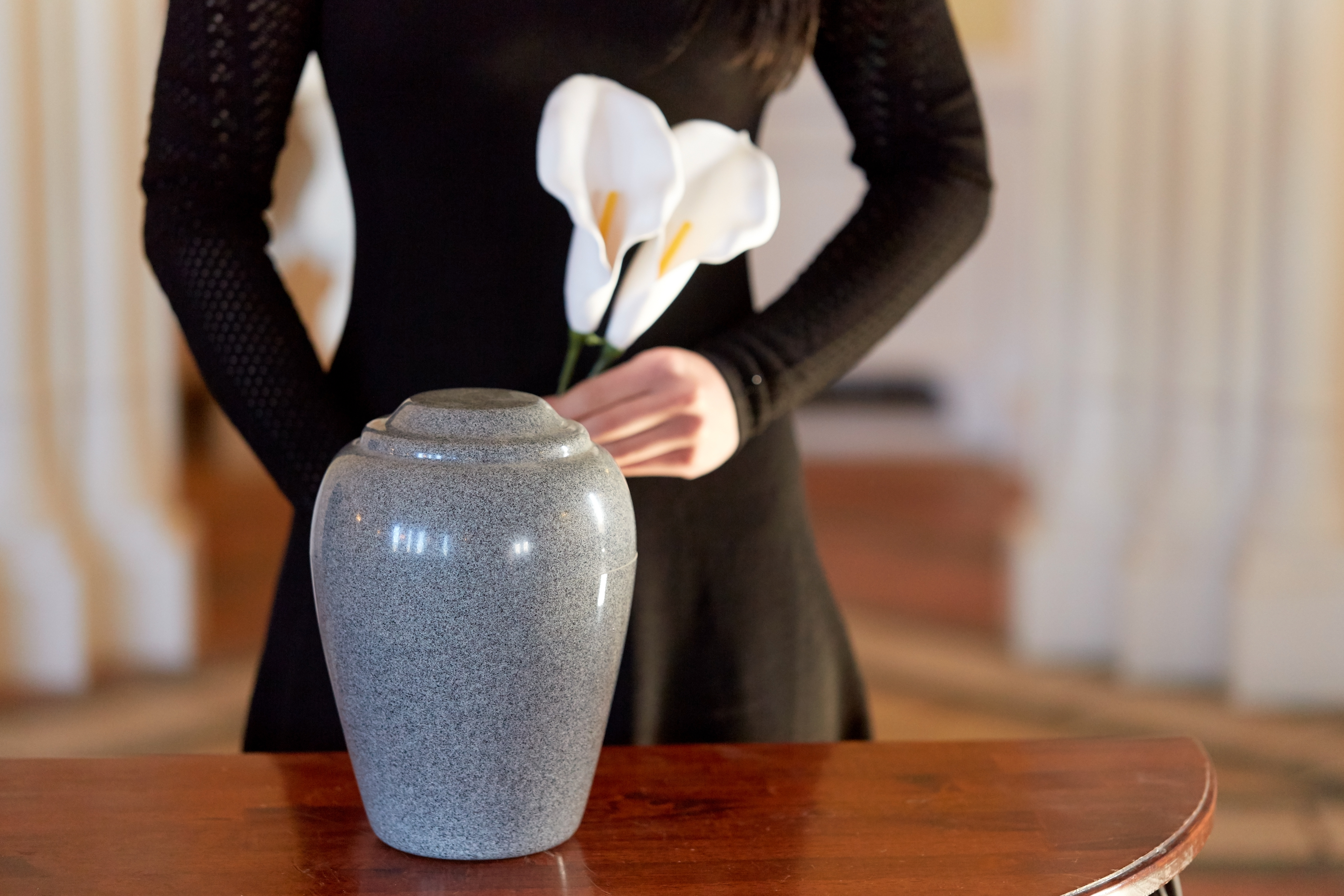 Memorial service ceremony — an urn with white calla lilies during a remembrance ceremony on the Sunshine Coast